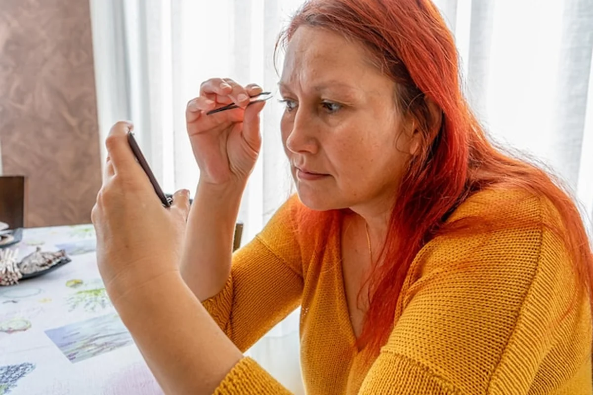 Kobieta dbająca o brwi przed słońcem, po makijażu permanentnym w domu